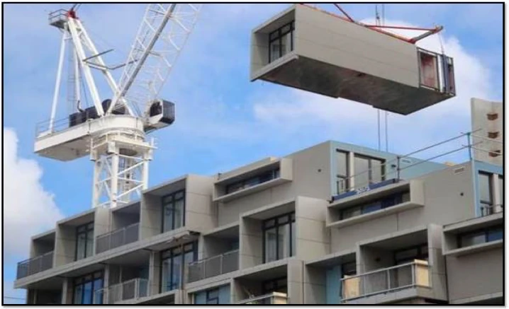 Prefabricated volumetric module being lifted into place by crane